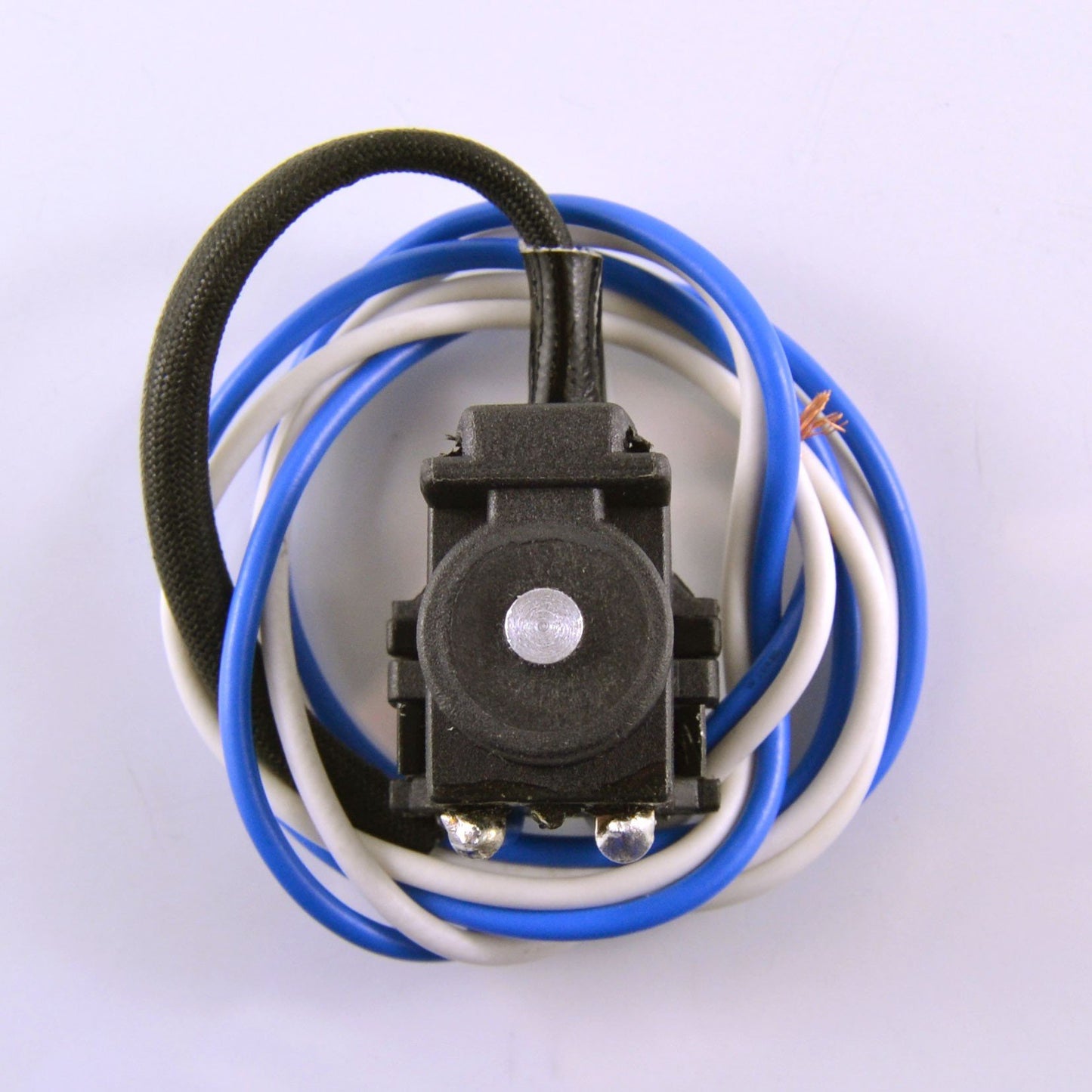 Black electrical pickup coil with blue and white wires coiled on white background