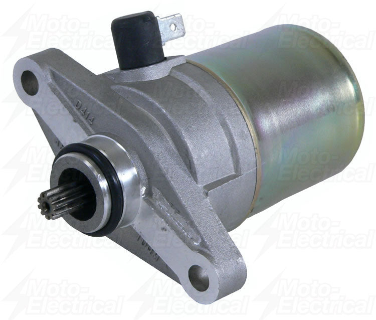 silver automotive starter motor with gear and mounting flange on white background