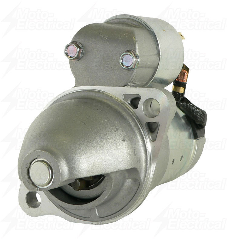Close-up of a silver automotive starter motor with mounting holes and electrical connections