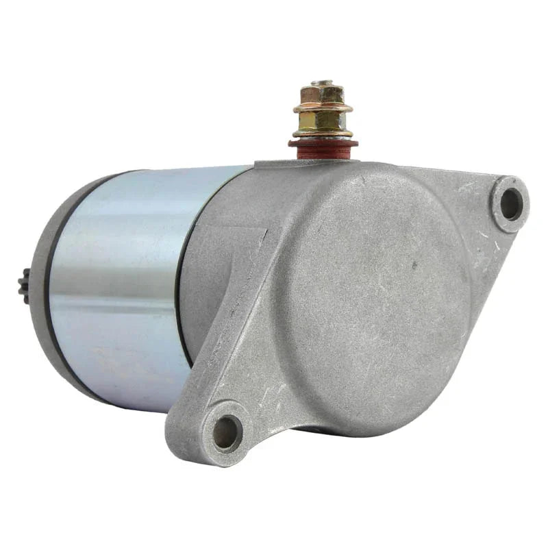 Silver electric starter motor with mounting holes and copper terminal on white background