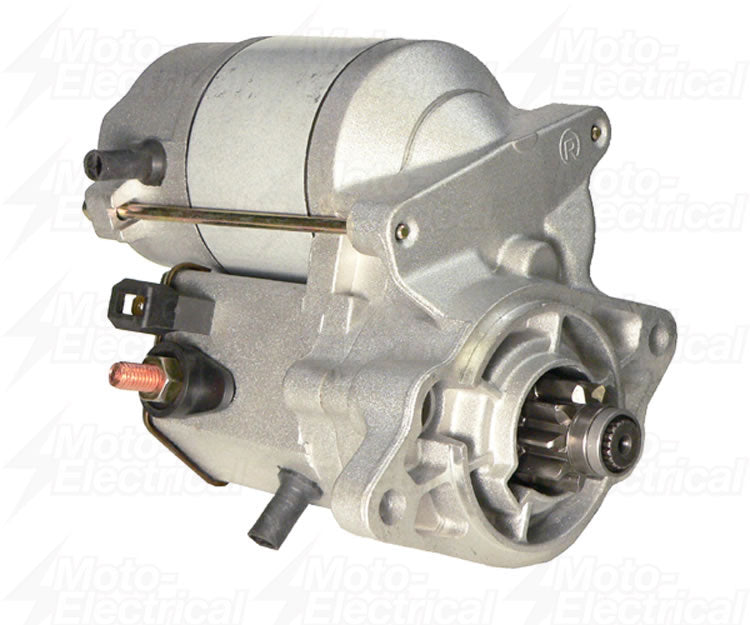 Close-up of a silver automotive starter motor with visible pinion gear and electrical terminals