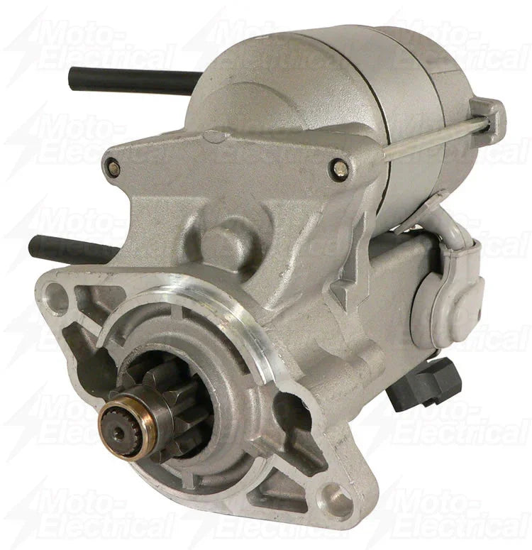 Silver automotive starter motor with visible gear and mounting points on white background