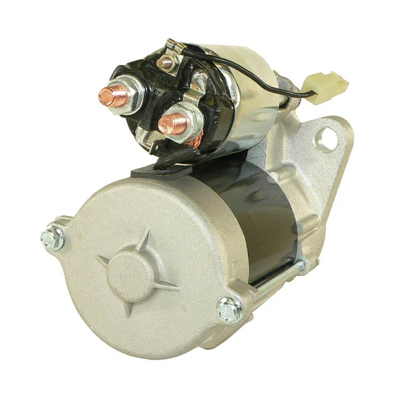 Silver and black automotive starter motor with copper terminals and mounting bracket on white background