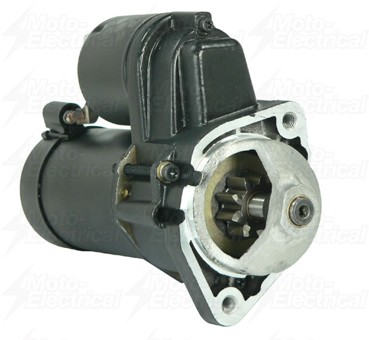 Close-up of black automotive starter motor with visible gear and mounting holes