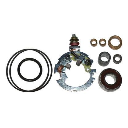 Assorted motor brush holder components, O-rings, bushings, and bearings on white background