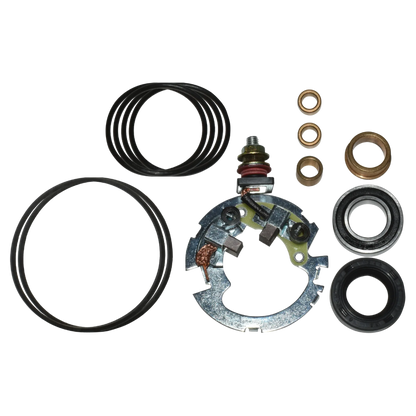 Assorted mechanical repair parts including metal brush holder, rubber O-rings, and bronze bushings on black background