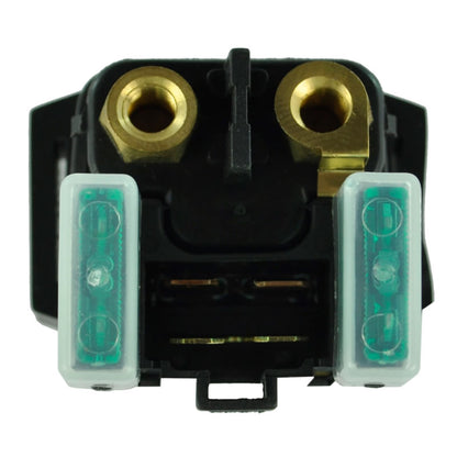 Close-up of black automotive fuse holder with two green fuses and brass terminals