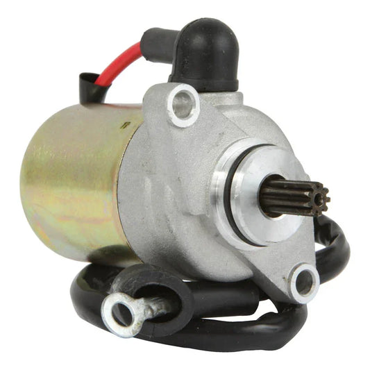 Close-up of a silver and gold electric starter motor with red and black wires on a white background